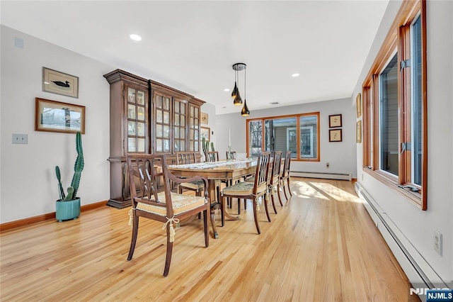 dining room with light wood-style floors, baseboards, baseboard heating, and recessed lighting