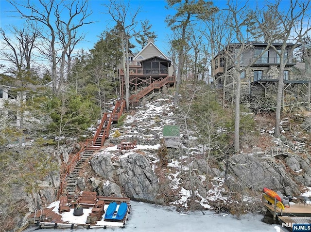 exterior space featuring a sunroom and stairs