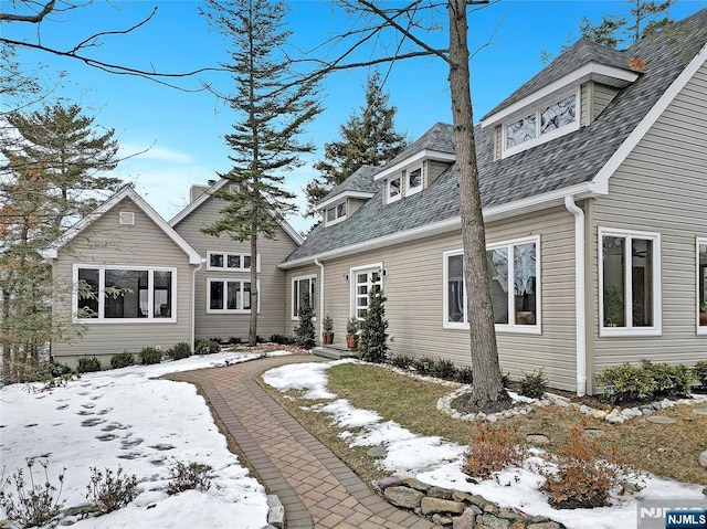 exterior space with a shingled roof