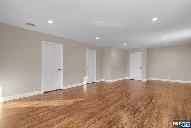 spare room with visible vents, wood finished floors, and recessed lighting