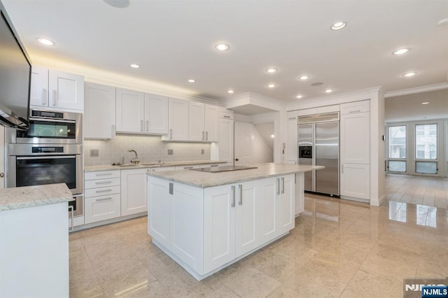 kitchen featuring backsplash, a kitchen island with sink, white cabinets, stainless steel built in fridge, and black electric cooktop