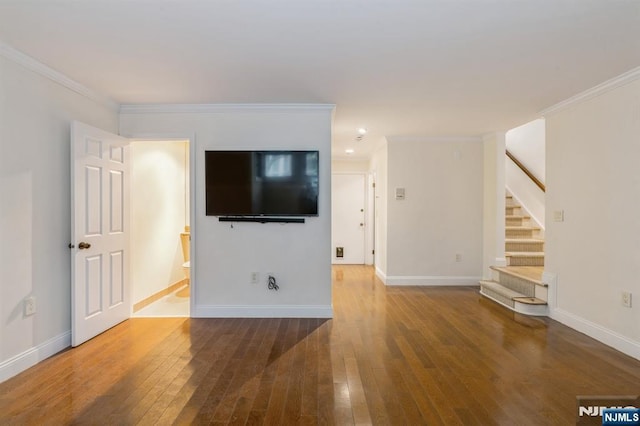 unfurnished living room featuring baseboards, stairway, dark wood finished floors, and ornamental molding