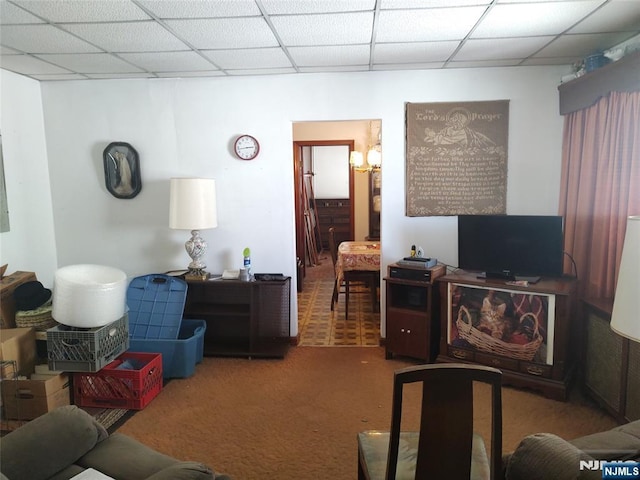 living room with carpet floors and a drop ceiling