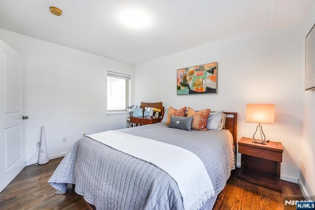 bedroom featuring baseboards and wood finished floors