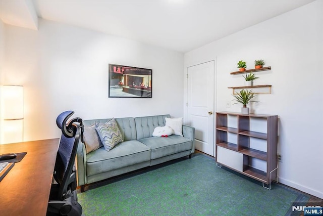 carpeted living area featuring baseboards