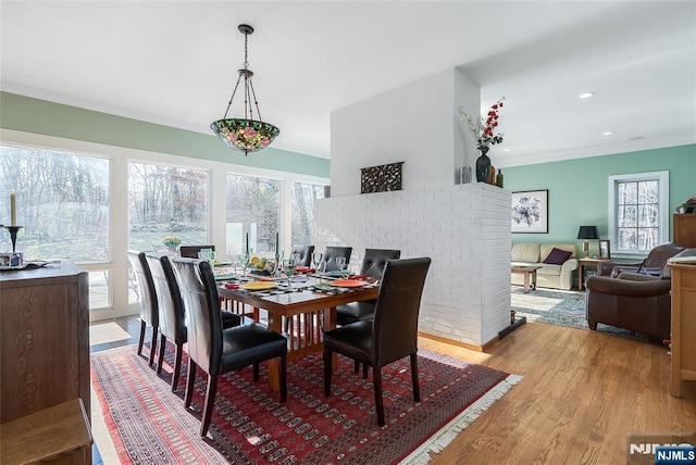 dining space with light wood-style floors, recessed lighting, and ornamental molding