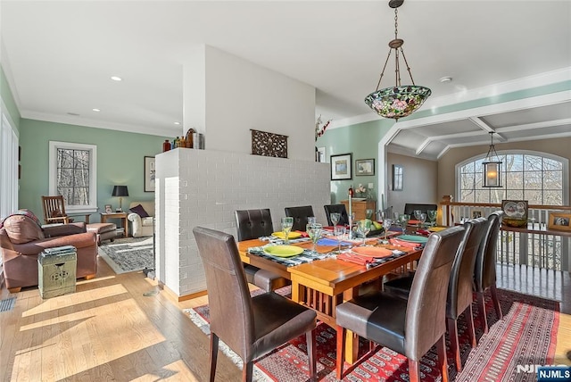 dining room featuring light wood finished floors, recessed lighting, and crown molding