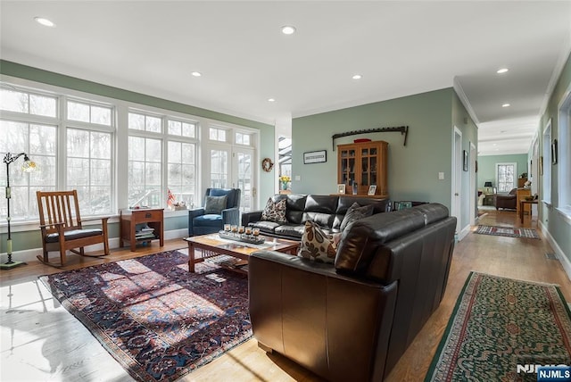 living area featuring light wood-style floors, recessed lighting, and a healthy amount of sunlight