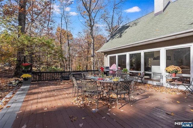 wooden terrace with outdoor dining space