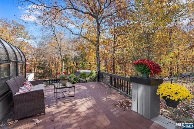 wooden terrace with an outdoor living space