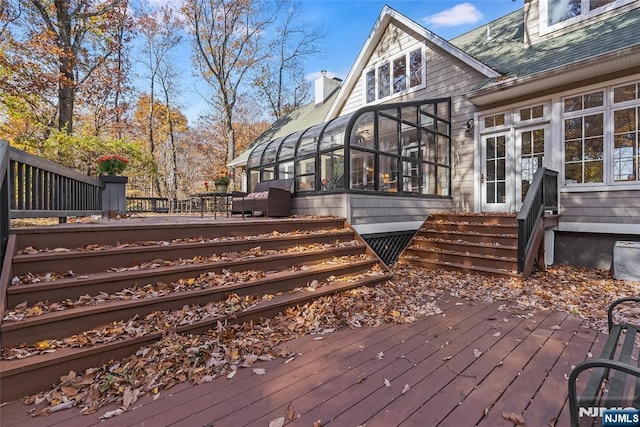 deck with entry steps and a sunroom