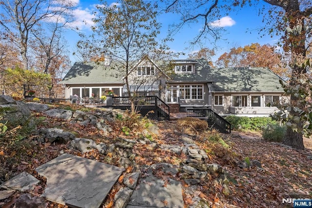 rear view of property with a deck and stairway