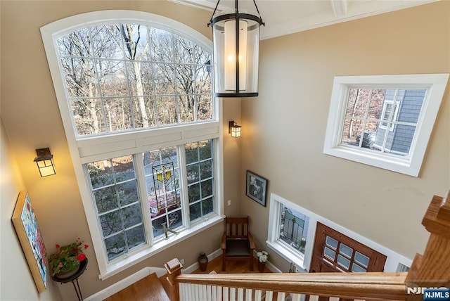 staircase featuring ornamental molding and baseboards