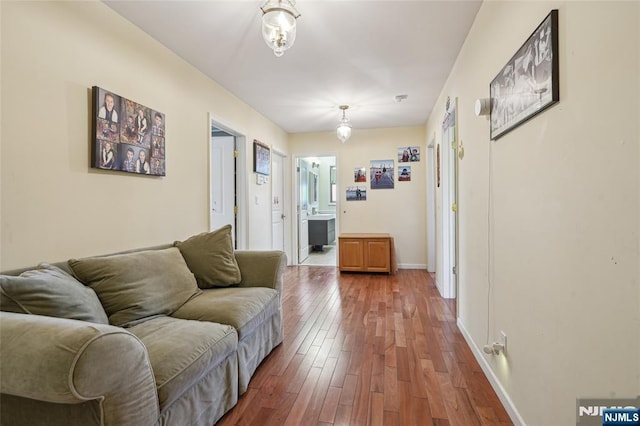 living area featuring baseboards and wood finished floors