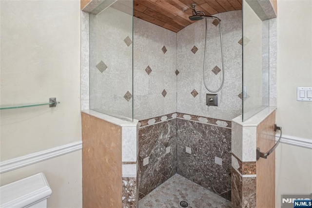 bathroom featuring wood ceiling and tiled shower