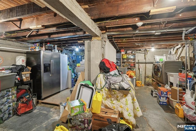 unfinished below grade area featuring stainless steel fridge and washing machine and clothes dryer