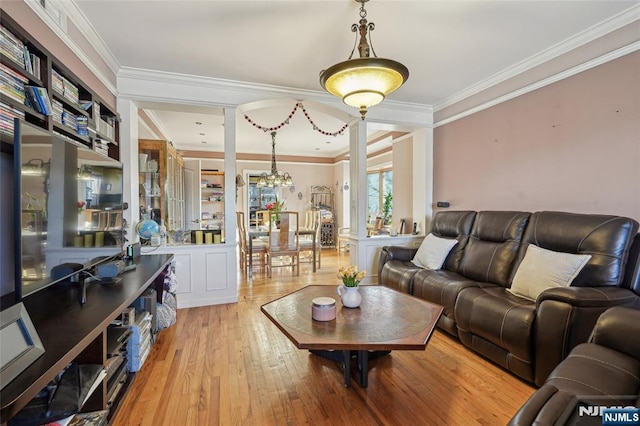 living room with ornamental molding and light wood-type flooring