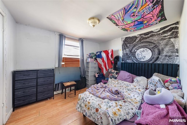 bedroom featuring light wood-style flooring