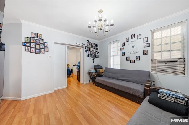 living area featuring baseboards, crown molding, an inviting chandelier, and wood finished floors