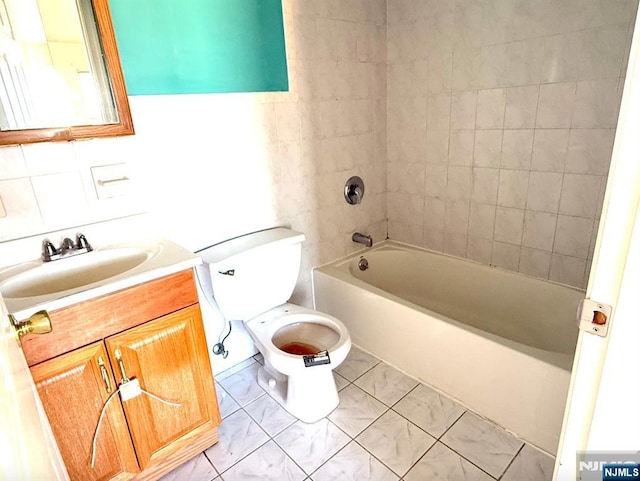 bathroom featuring vanity, toilet, and bathing tub / shower combination