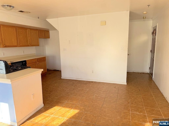 kitchen featuring light tile patterned floors, visible vents, brown cabinetry, light countertops, and crown molding