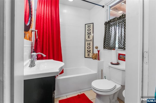 bathroom featuring toilet, tile patterned floors, shower / bathtub combination, and vanity