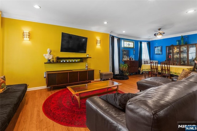 living room with ornamental molding, wood finished floors, and recessed lighting