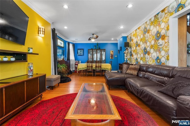 living area with ornamental molding, wood finished floors, and recessed lighting