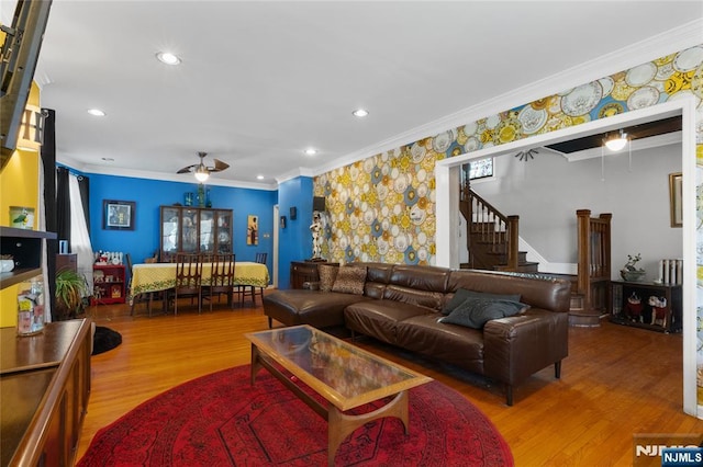 living area with recessed lighting, stairway, ornamental molding, a ceiling fan, and wood finished floors