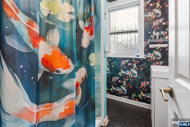 bathroom with vanity and baseboards