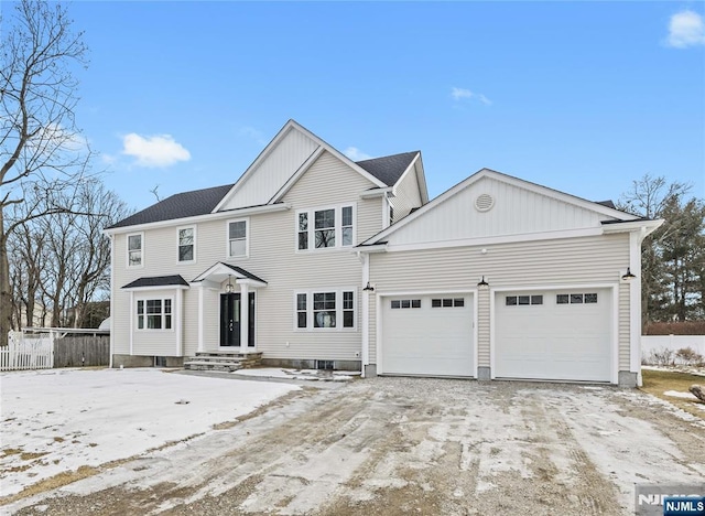 view of front facade with a garage and fence