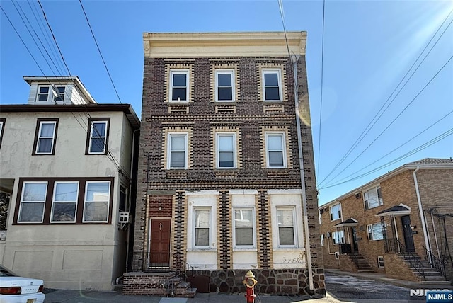 townhome / multi-family property featuring brick siding