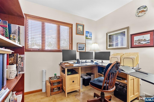 office space with light carpet and baseboards