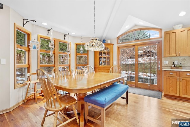 dining room with vaulted ceiling, light wood-style flooring, and recessed lighting