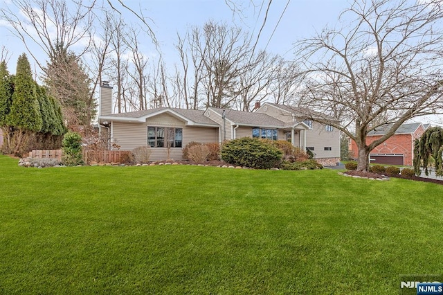 view of front of property with a front lawn and a chimney