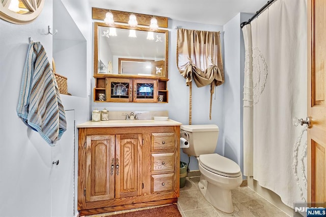 full bathroom with toilet, a shower with shower curtain, vanity, and tile patterned floors