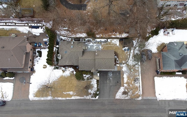 snowy aerial view with a residential view