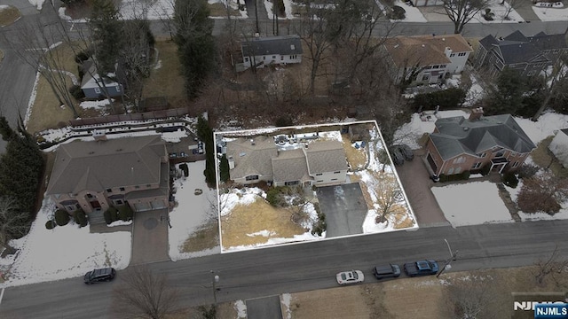 snowy aerial view with a residential view