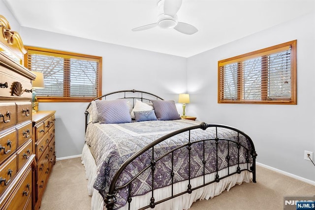 bedroom featuring light carpet, ceiling fan, and baseboards