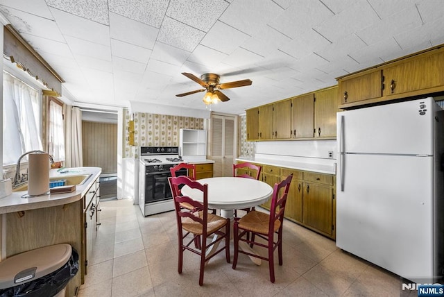 dining area with wallpapered walls, a ceiling fan, and light tile patterned flooring