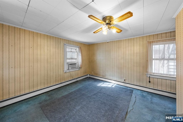 spare room with wallpapered walls, plenty of natural light, dark carpet, and a baseboard heating unit