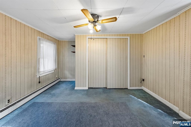 empty room featuring a baseboard heating unit, ornamental molding, and wallpapered walls