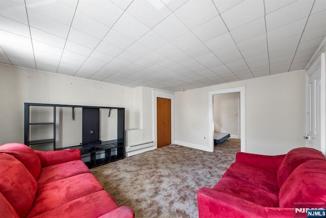 living room with a baseboard radiator, baseboards, and carpet flooring