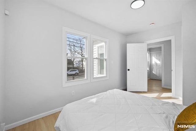 bedroom featuring light wood-type flooring and baseboards