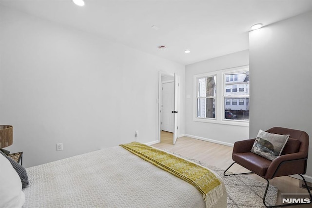 bedroom with recessed lighting, light wood-style flooring, and baseboards