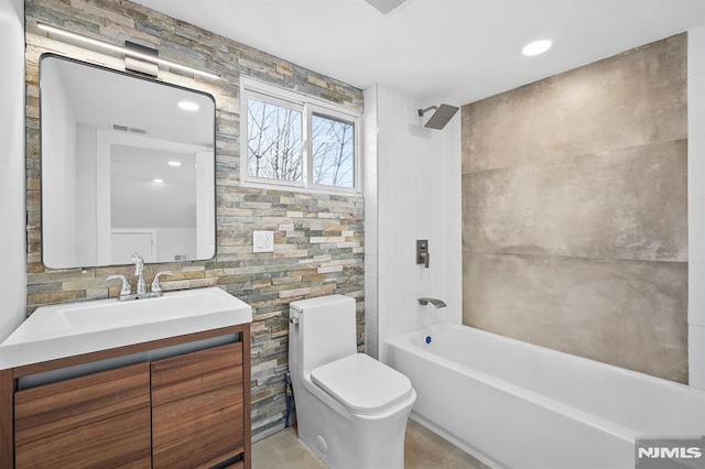 bathroom with toilet, visible vents, tub / shower combination, and vanity