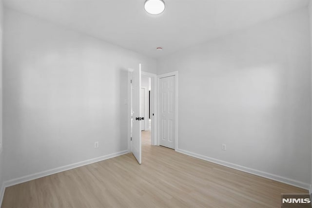 unfurnished bedroom featuring light wood-type flooring and baseboards