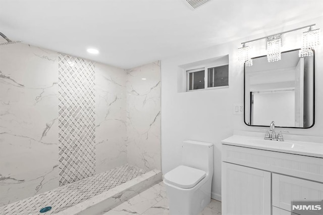 bathroom featuring toilet, visible vents, vanity, marble finish floor, and a marble finish shower