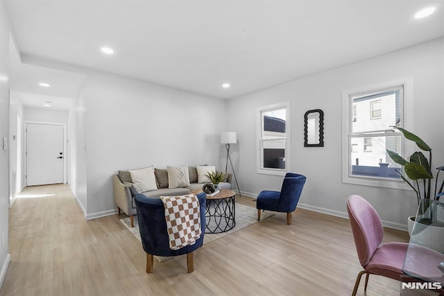 living area with light wood-type flooring and recessed lighting