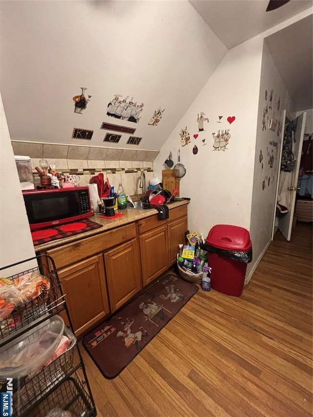 recreation room with lofted ceiling and wood finished floors